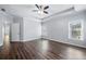 Spacious bedroom featuring tray ceilings, hardwood flooring, and natural light at 3826 Baxley Village Trl, Suwanee, GA 30024