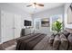 Beautiful bedroom featuring hardwood floors, large windows, a ceiling fan, and gray accent walls at 3826 Baxley Village Trl, Suwanee, GA 30024