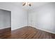 Bright bedroom featuring hardwood floors, neutral paint, a ceiling fan, and closet at 3826 Baxley Village Trl, Suwanee, GA 30024
