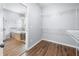 Spacious closet featuring hardwood floors and wire shelving adjacent to the bathroom with a tub at 3826 Baxley Village Trl, Suwanee, GA 30024