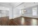 Light-filled dining room with modern chandelier, dark wood floors, and elegant wainscoting at 3826 Baxley Village Trl, Suwanee, GA 30024