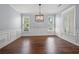 Bright dining room featuring modern lighting fixture and detailed wainscoting at 3826 Baxley Village Trl, Suwanee, GA 30024