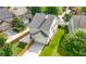 View of back of home with two-car garage, green lawn, and wooden fence at 3826 Baxley Village Trl, Suwanee, GA 30024