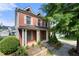 Charming two-story brick home featuring a welcoming front porch, well-maintained landscaping, and inviting curb appeal at 3826 Baxley Village Trl, Suwanee, GA 30024