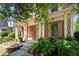Inviting front porch with brick facade, classic columns, a landscaped garden bed, and sidewalk at 3826 Baxley Village Trl, Suwanee, GA 30024