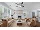Bright living room featuring a fireplace, built-in shelving, large windows, and stylish furnishings at 3826 Baxley Village Trl, Suwanee, GA 30024