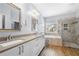 Bright primary bathroom features dual sinks, a soaking tub, and a walk-in shower at 3826 Baxley Village Trl, Suwanee, GA 30024