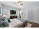 Primary bedroom with hardwood floors, ceiling fan, and ensuite bathroom, with lots of light at 3826 Baxley Village Trl, Suwanee, GA 30024