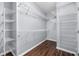 Organized walk-in closet with ample shelving and hardwood floors at 3826 Baxley Village Trl, Suwanee, GA 30024