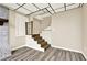 Partially finished basement with wood flooring, brick fireplace and access to wooden stairs at 4353 White Oak Dr, Sugar Hill, GA 30518