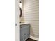 A cozy bathroom features a granite countertop, round mirror, and horizontal wood paneling at 4353 White Oak Dr, Sugar Hill, GA 30518