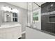 Bathroom featuring a glass shower, dark tile, and a modern vanity at 4353 White Oak Dr, Sugar Hill, GA 30518