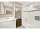 Bathroom featuring a white vanity, bathtub with mosaic accents, and access to another room at 4353 White Oak Dr, Sugar Hill, GA 30518