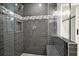 Modern walk-in shower with gray subway tile, a built-in bench, and glass surround at 4353 White Oak Dr, Sugar Hill, GA 30518