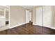 Bedroom featuring dark hardwood floors, white trim, and access to a bathroom and closet at 4353 White Oak Dr, Sugar Hill, GA 30518