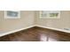 Neutral bedroom with windows, dark hardwood flooring, and white trim at 4353 White Oak Dr, Sugar Hill, GA 30518