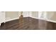 Open view of a bedroom with hardwood floors leading into the ensuite bathroom at 4353 White Oak Dr, Sugar Hill, GA 30518