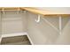 Walk-in closet offers wooden shelf and clothing rod for organized storage solutions at 4353 White Oak Dr, Sugar Hill, GA 30518