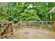 Wood deck with nice railing looking into a wooded backyard and playground at 4353 White Oak Dr, Sugar Hill, GA 30518
