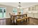 Lovely dining room showcasing a rustic table, a bench, and bright windows at 4353 White Oak Dr, Sugar Hill, GA 30518