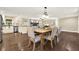 Beautiful dining room featuring hardwood floors and an open layout with an adjacent kitchen at 4353 White Oak Dr, Sugar Hill, GA 30518