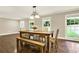 Cozy dining area with hardwood floors, a rustic table, and ample natural light at 4353 White Oak Dr, Sugar Hill, GA 30518