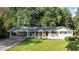 Charming single-story home with a well-maintained lawn and a covered carport at 4353 White Oak Dr, Sugar Hill, GA 30518