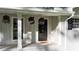 Close-up of front porch with flowers and a decorative front door at 4353 White Oak Dr, Sugar Hill, GA 30518