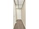 A freshly painted hallway, brightly lit, showcases the home's stylish, neutral toned, vinyl flooring at 4353 White Oak Dr, Sugar Hill, GA 30518
