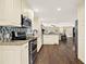 Modern kitchen with stainless steel appliances, granite countertops, and stylish backsplash at 4353 White Oak Dr, Sugar Hill, GA 30518