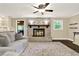 Charming living room with a brick fireplace and an abundance of natural light at 4353 White Oak Dr, Sugar Hill, GA 30518