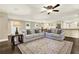 Open living room with two couches, a rug, and hardwood floors at 4353 White Oak Dr, Sugar Hill, GA 30518