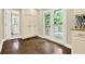 Bright living space with hardwood floors, built-in cabinets, and access to a deck through French doors at 4353 White Oak Dr, Sugar Hill, GA 30518