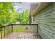 Outdoor space on a wooden back deck, with view to green trees and backyard at 6015 Sumit Nw Ct, Kennesaw, GA 30152