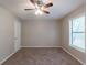 Bright bedroom featuring a ceiling fan and a large window for natural light at 6015 Sumit Nw Ct, Kennesaw, GA 30152