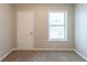 Bedroom with carpet flooring, a window for natural light, and a closet at 6015 Sumit Nw Ct, Kennesaw, GA 30152
