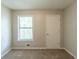 Bedroom with neutral walls, a window and a closet door at 6015 Sumit Nw Ct, Kennesaw, GA 30152