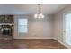 Dining room featuring a stone fireplace, wood floors, and a modern chandelier at 6015 Sumit Nw Ct, Kennesaw, GA 30152