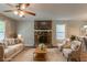 Staged living room featuring a stone fireplace, comfortable seating, and stylish decor at 6015 Sumit Nw Ct, Kennesaw, GA 30152