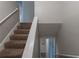 Carpeted staircase with white railing leading to the upper level at 6015 Sumit Nw Ct, Kennesaw, GA 30152