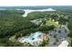 Community aerial view featuring a pool, lake, green space, and residential area at 101 Misty Valley Dr, Canton, GA 30114