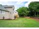 Manicured backyard featuring a spacious lawn, wooden deck, and mature trees for a serene outdoor setting at 101 Misty Valley Dr, Canton, GA 30114