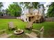 Landscaped backyard featuring a fire pit with Adirondack chairs, creating a cozy outdoor gathering space at 101 Misty Valley Dr, Canton, GA 30114