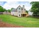 Expansive backyard showcasing lush green grass and a wooden deck, ideal for outdoor activities and enjoyment at 101 Misty Valley Dr, Canton, GA 30114