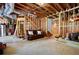 Unfinished basement with exposed ductwork, wood framing, and a cozy brown couch, ready for customization at 101 Misty Valley Dr, Canton, GA 30114