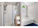 Bathroom featuring a walk-in shower with glass enclosure and soaking tub at 101 Misty Valley Dr, Canton, GA 30114