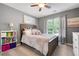 Bedroom with a plush bed, side table, and bright, sunlit window at 101 Misty Valley Dr, Canton, GA 30114