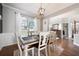 Cozy dining room with hardwood floors, large windows and neutral colored walls at 101 Misty Valley Dr, Canton, GA 30114