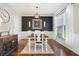 Formal dining room with modern lighting fixture, hardwood floors, and elegant decor at 101 Misty Valley Dr, Canton, GA 30114