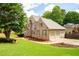 Charming brick home featuring a well-manicured lawn, mature landscaping, and a spacious two-car garage at 101 Misty Valley Dr, Canton, GA 30114